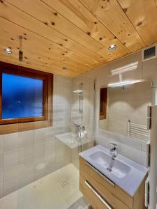 a bathroom with two sinks and a mirror at Résidences Delavay La Cordée in Les Gets +28 photos