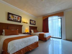 Ένα ή περισσότερα κρεβάτια σε δωμάτιο στο Gran Real Yucatan +56 φωτογραφίες