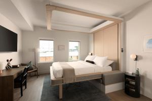 a bedroom with a bed and a desk and a desk at Mint House Tampa Downtown by Kasa in Tampa +19 photos