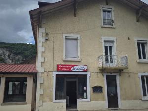 a building with a sign on the side of it at Le létilo in Saint-Claude
