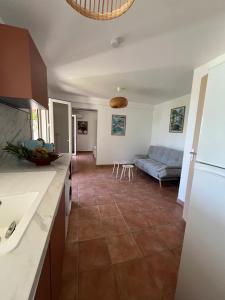 a kitchen and living room with a blue couch at O Ti Boneur in Sainte-Rose +18 photos