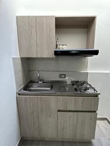 a kitchen with a sink and a stove at Yellow House in Manizales