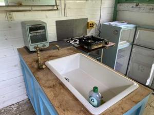 a kitchen counter with a sink and a stove at Little North Campground - Vacation STAY 69019v in Kajikazawa