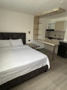 a bedroom with a bed and a desk in it at Yellow House in Manizales