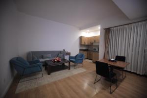 a living room with a couch and chairs and a table at Hotel Boutique Elmos - Meskel Flower in Addis Ababa +22 photos