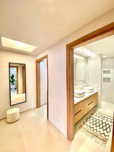 a bathroom with two sinks and a mirror at Aurelia Residence in Ampavris +95 photos