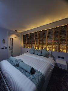 a bedroom with a large white bed with blue pillows at Petra Masterpiece in Wadi Musa