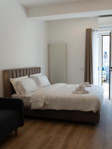 a bedroom with a large bed with white pillows at VILLA ISABELLA Ospedale Cisanello in Pisa