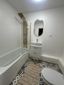 a bathroom with a toilet and a sink and a mirror at Nocleg Słupsk - Kwatera do 5 osób Kuchnia TV WiFi in Słupsk