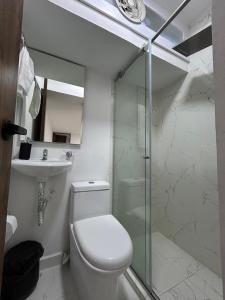 a bathroom with a toilet and a sink and a shower at Casa Vernazza in Manizales +35 photos