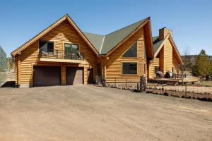 a wooden house with a driveway in front of it at Mtn Views and Fall Colors Panguitch 1-Acre Estate! in Panguitch