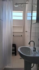 a bathroom with a sink and a shower at Suíte Harmonia 1 in Campo Grande