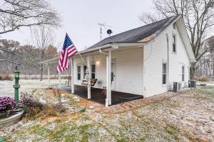 a small white house with an american flag on it at Pet-Friendly Home with River Access in Crothersville in Scottsburg