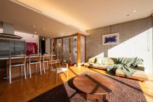 a living room with a couch and a table at USHIMADO Villa - Vacation STAY 61741v in Setouchi