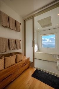 a bathroom with a sliding glass door with a window at USHIMADO Villa - Vacation STAY 61741v in Setouchi +74 photos