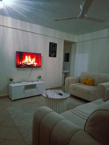 a living room with a fire on the wall at Evara Luxe stay in Mombasa