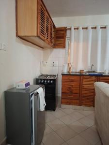 a small kitchen with a stove and a sink at Evara Luxe stay in Mombasa