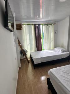 Ένα ή περισσότερα κρεβάτια σε δωμάτιο στο Casa hostal Disney