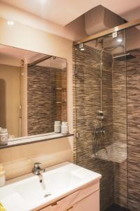 a bathroom with a sink and a shower at Beachfront Apt in Aourir Pool, Surf & Comfort in Aourir