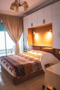 a bedroom with a bed and a large window at Beachfront Apt in Aourir Pool, Surf & Comfort in Aourir