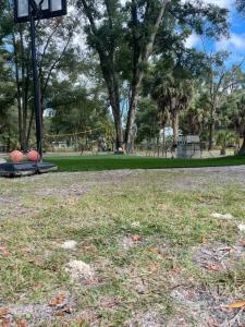 an empty park with a playground in the background at Neals Nest Cozy Cabin in Chiefland +4 photos