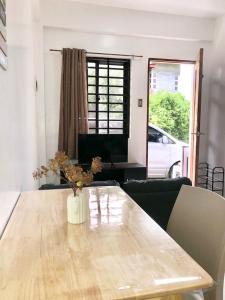 a living room with a table with a vase on it at Serenity home sweet home in Tuguegarao City