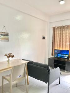 a living room with a couch and a table at Serenity home sweet home in Tuguegarao City +5 photos