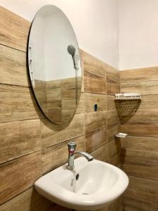 a bathroom with a sink and a mirror at Serenity home sweet home in Tuguegarao City