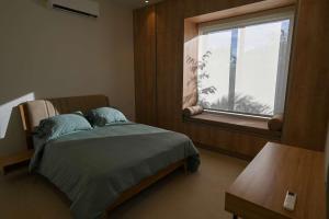 a hospital room with a bed and a window at Oceanview Home with Pool in Venao in Playa Venao