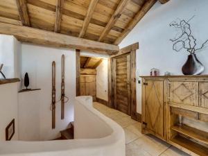 a bathroom with a tub and a wooden ceiling at Chalet prestige 4 chambres, hammam, cheminée, conciergerie - FR-1-694-365 in Val dʼIsère +15 photos