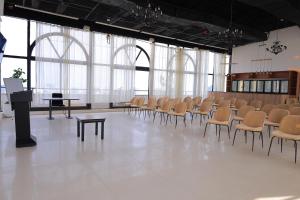 a large room with chairs and a podium in it at Hotel Boutique Elmos - Meskel Flower in Addis Ababa