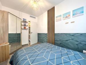 a bedroom with a blue bed in a room at Modern Luxury - Sea View over Èze Village in Èze