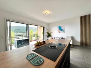 a kitchen with a wooden counter top in a room at Modern Luxury - Sea View over Èze Village in Èze