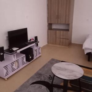 un soggiorno con tv e tavolo di Pamsal Studio a Thika 1 altra foto