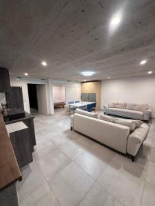 a living room with two couches and a table at Innsbruck West in Inzing