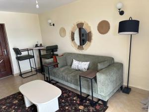 a living room with a couch and a table at Lakeview Apartments - The Nest in Mbita