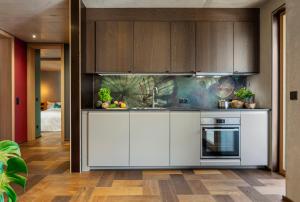 a kitchen with white cabinets and a stove at bläkat in Ramsau im Zillertal