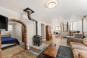 a living room with a fireplace and a stove at 4 Bedroom full house with 4 car parking in Kingston