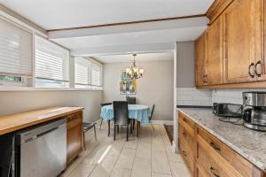 a kitchen with a table and a dining room at 4 Bedroom full house with 4 car parking in Kingston
