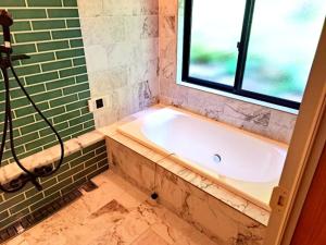 a bath tub in a bathroom with a window at Cottage Flamingo - Vacation STAY 58478v in Minato +11 photos