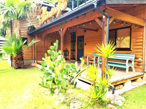 a wooden house with a bench on a porch at Cottage Flamingo - Vacation STAY 58478v in Minato