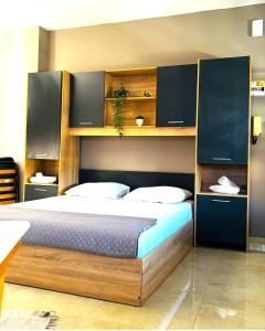 um quarto com uma cama com cabeceira de madeira em Downtown Studio 31 em Serres