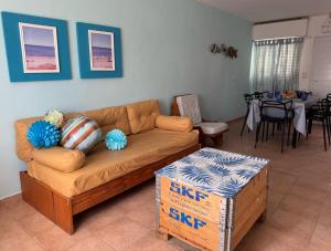 a living room with a couch and a table at Las Grutas Star in Las Grutas