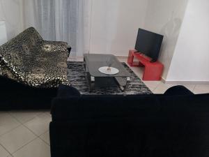 a living room with two chairs and a coffee table at sofi in Komotini