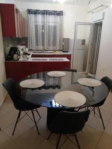 a kitchen with a table and chairs in a kitchen at sofi in Komotini +9 photos