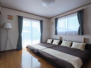 En eller flere senge i et værelse på Misaki Guesthouse - Vacation STAY 20495