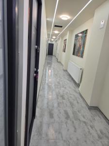 a hallway of an office building with a long corridor at Jessica luxury Apartament in Curtea de Argeş