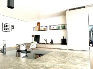 a kitchen with white walls and a counter top at Ferienwohnung Im Dorf Urnäsch in Urnäsch +19 photos