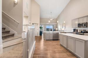 a large kitchen with white cabinets and wooden floors at The Lakeview Penthouse - 10ppl in Branson