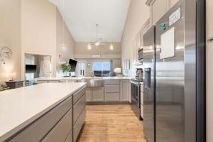 a kitchen with white cabinets and stainless steel appliances at The Lakeview Penthouse - 10ppl in Branson
